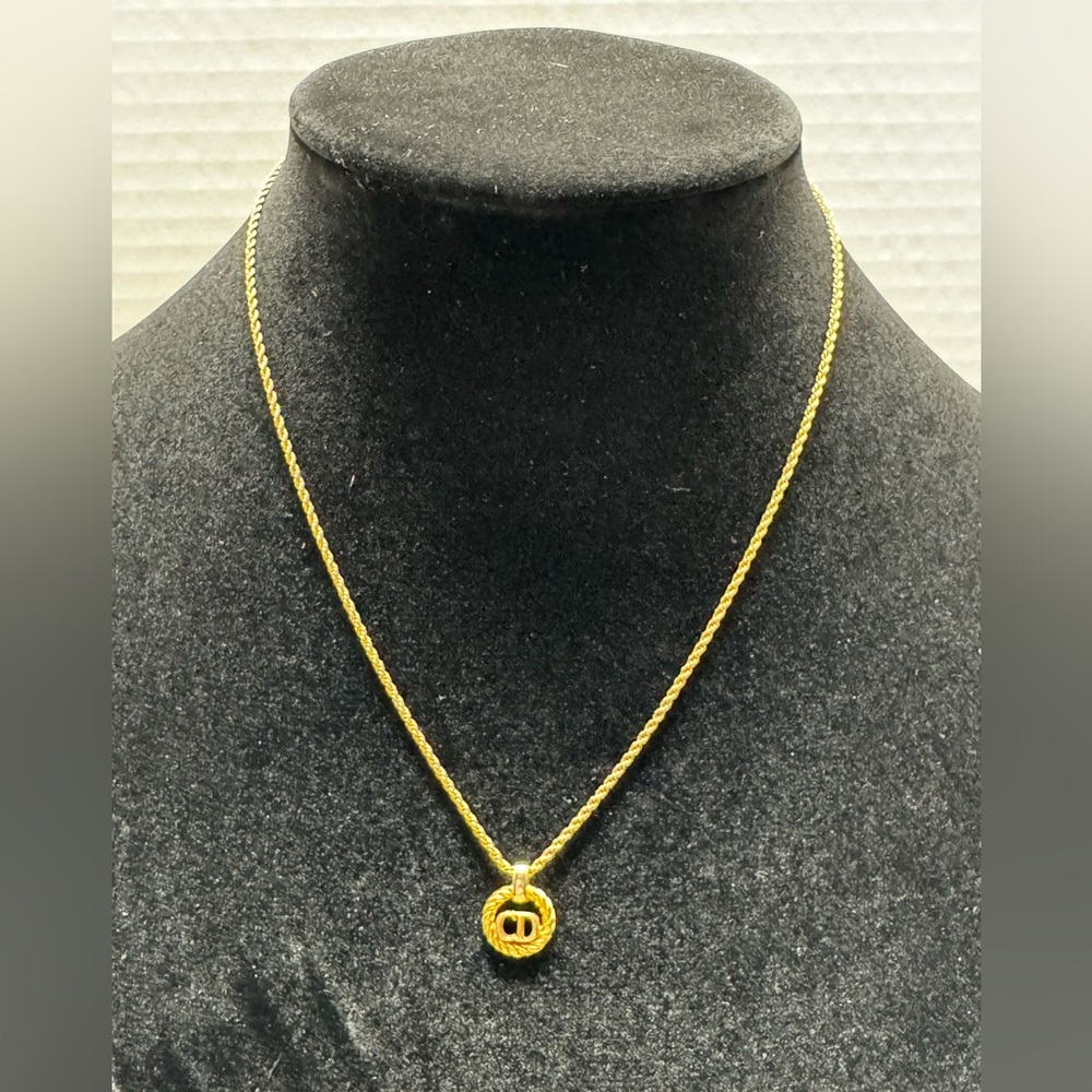 Vintage Christian Dior CD logo round circle necklace in gold-plated metal.
